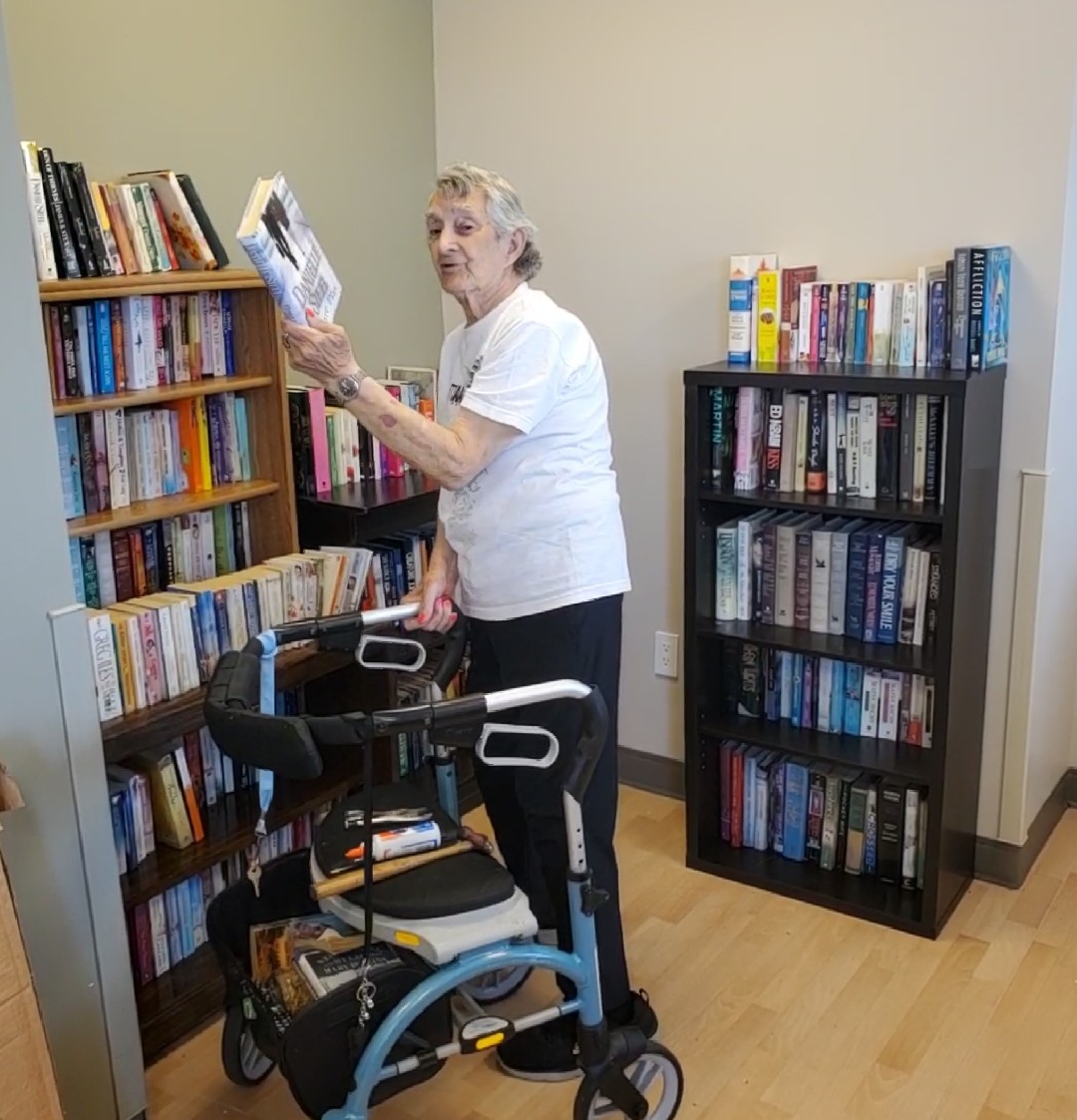 Mackay resident Tony Beulow picking out a book from the new library. 
